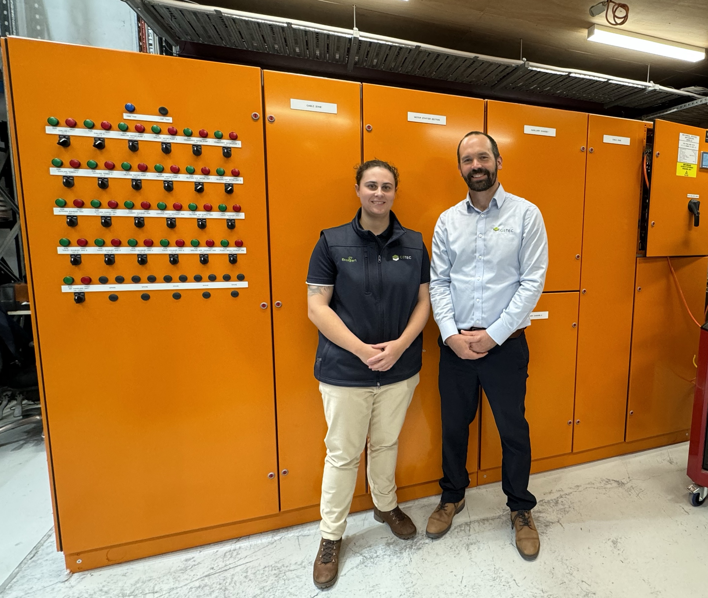 One of GSTEC’s newest apprentices, Isobel Demol, left. Isobel has gone through the switchboard and commissioning rotation and is currently working in the BMS remote engineering support team. Right is GSTEC General Manager, Liam Casey, who began as an apprentice 25 years ago